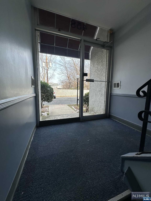 doorway to outside with carpet floors