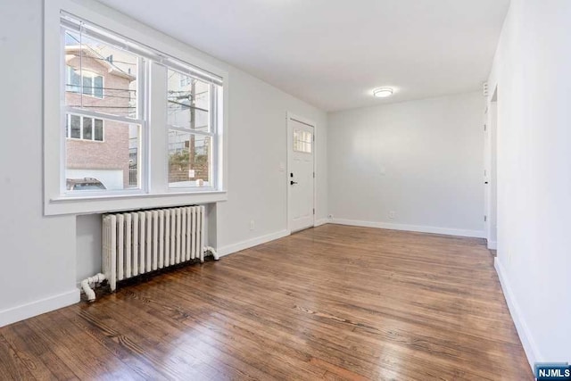 entryway featuring radiator heating unit and dark hardwood / wood-style floors