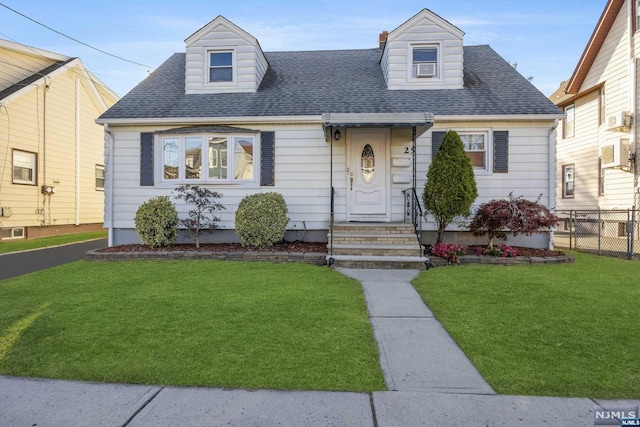 cape cod house with a front yard