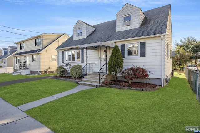 cape cod-style house with a front lawn