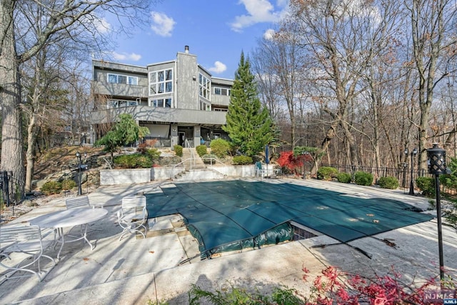 view of swimming pool featuring a patio area