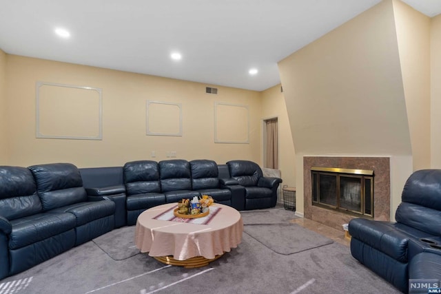 living room with a high end fireplace and light colored carpet