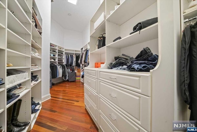 spacious closet with dark hardwood / wood-style floors