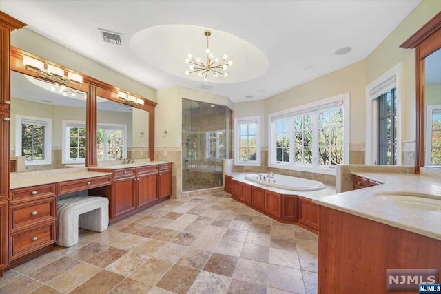 bathroom featuring a chandelier, vanity, tile walls, and plus walk in shower