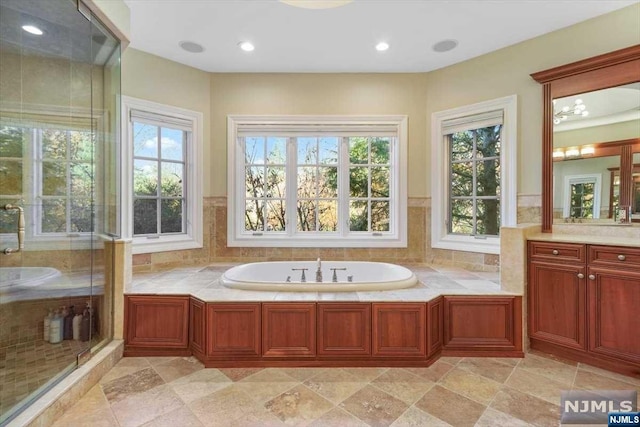 bathroom featuring plus walk in shower and vanity