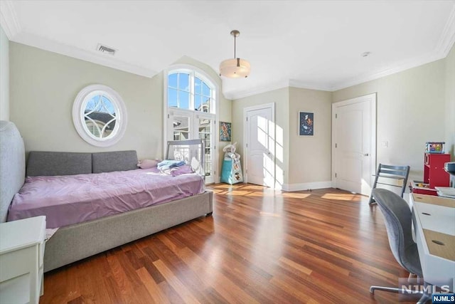 bedroom with hardwood / wood-style flooring and crown molding