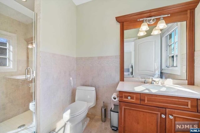 bathroom featuring vanity, toilet, tile walls, walk in shower, and a chandelier