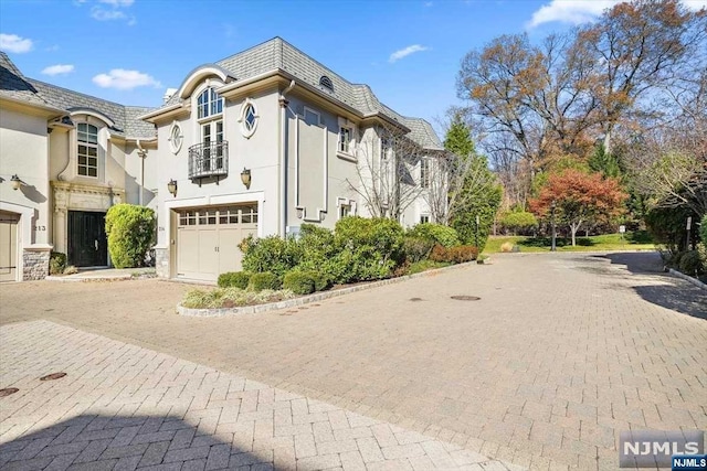 view of front facade with a balcony and a garage