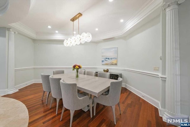 dining space with dark hardwood / wood-style floors, a raised ceiling, and ornamental molding