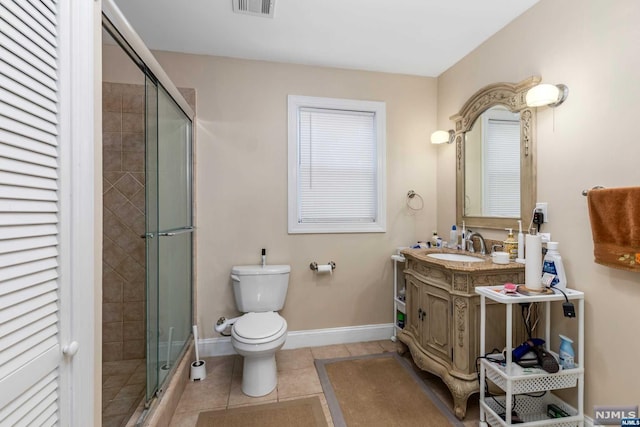 bathroom with toilet, vanity, tile patterned floors, and an enclosed shower