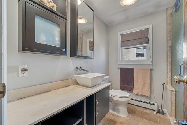 bathroom featuring toilet, vanity, and a baseboard radiator