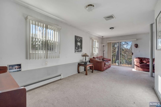 living area featuring a baseboard heating unit, a wealth of natural light, and carpet floors