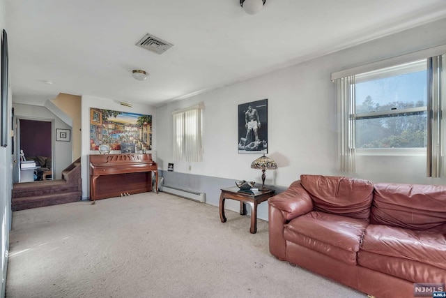 living room featuring light carpet, baseboard heating, and a healthy amount of sunlight