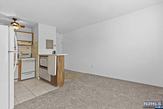 kitchen with decorative backsplash, light colored carpet, white appliances, and custom range hood