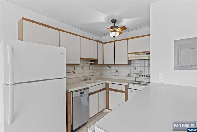 kitchen with decorative backsplash, white appliances, ventilation hood, and white cabinetry