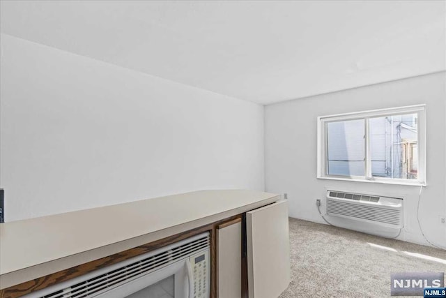 interior space with light carpet and a wall unit AC