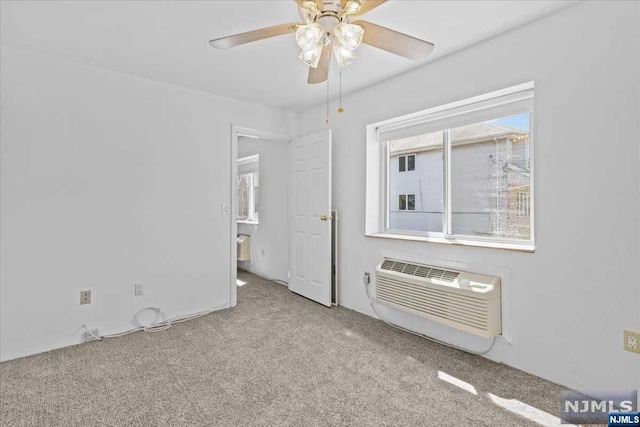 unfurnished room featuring ceiling fan, light colored carpet, and a wall mounted AC