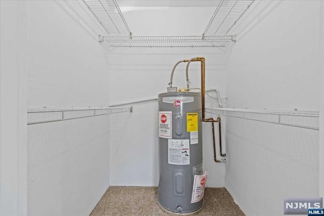 utility room featuring electric water heater