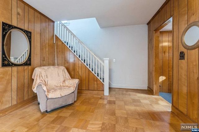 interior space with light parquet flooring and wooden walls