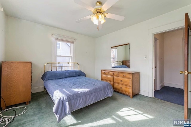 bedroom with ceiling fan and dark colored carpet