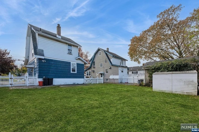 rear view of house with a lawn