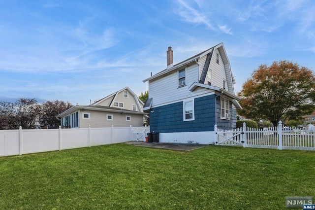 back of house featuring a yard and a patio