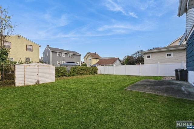 view of yard with a patio area and a shed