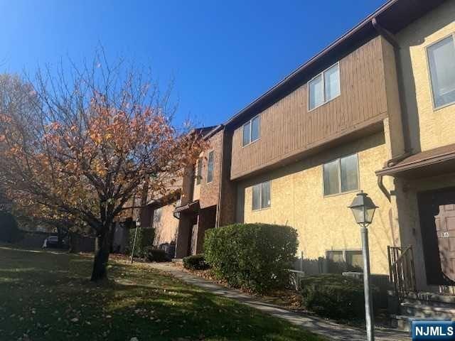 view of side of home with a lawn