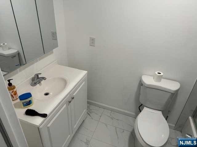 bathroom featuring vanity and toilet