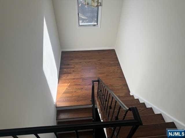 stairs featuring wood-type flooring