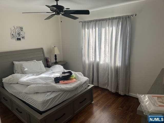 bedroom featuring ceiling fan and dark wood-type flooring