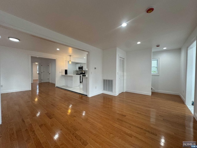 unfurnished living room featuring hardwood / wood-style flooring