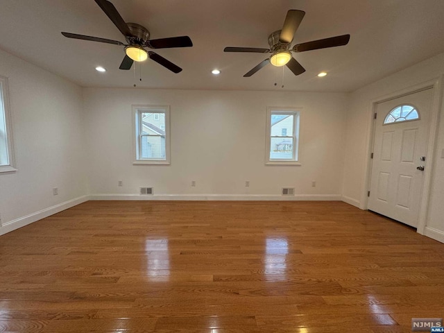 foyer with ceiling fan, light hardwood / wood-style flooring, and a healthy amount of sunlight