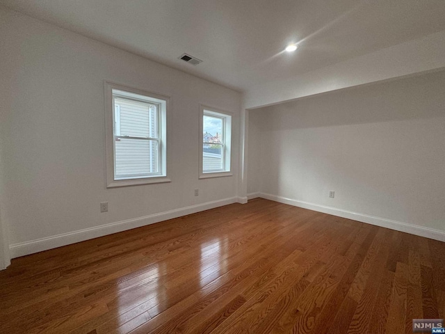 spare room with wood-type flooring