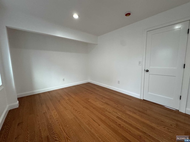 spare room with hardwood / wood-style flooring