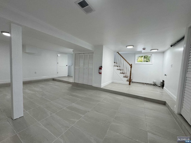 basement featuring light tile patterned floors