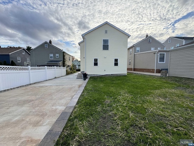 back of house with a lawn