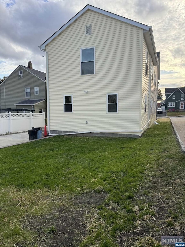 view of side of home featuring a lawn