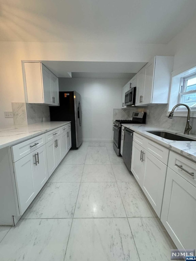 kitchen with white cabinets, stainless steel appliances, and sink