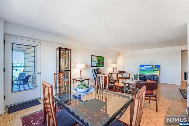 dining area featuring light parquet floors