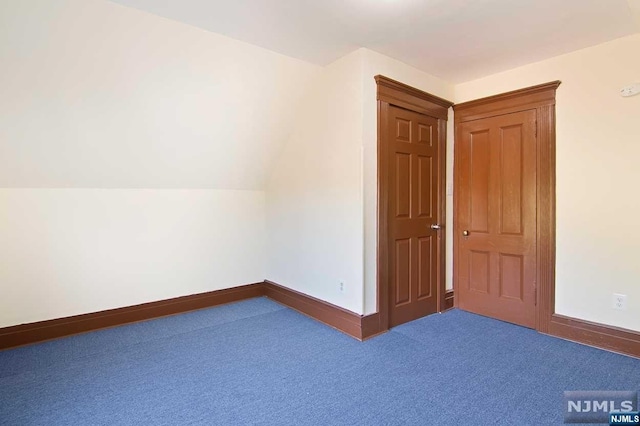 interior space with lofted ceiling and carpet floors