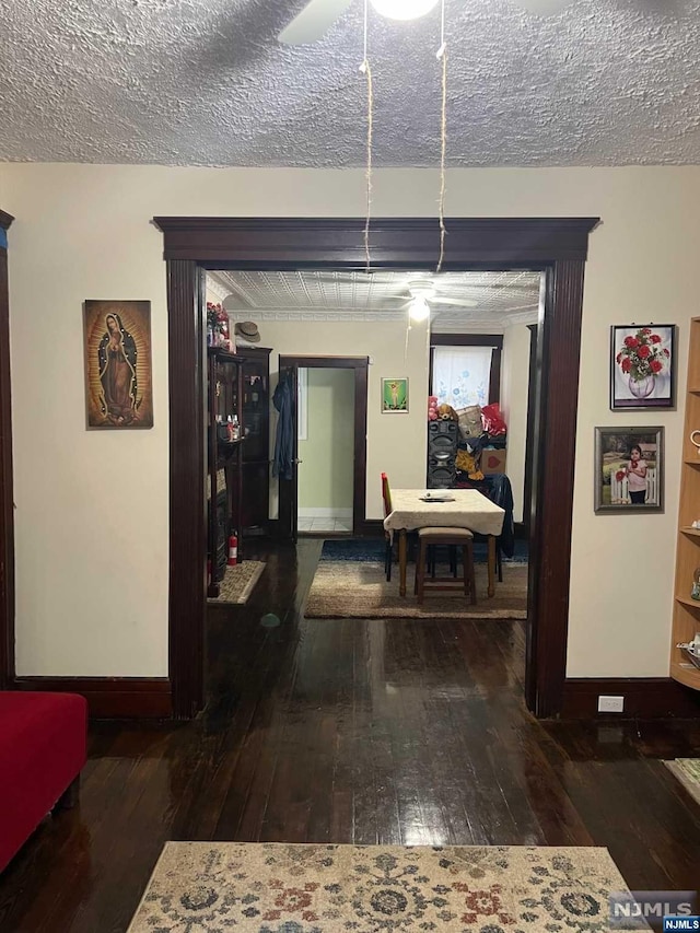 corridor with dark wood-type flooring and a textured ceiling