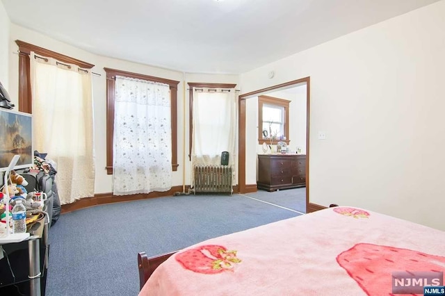 carpeted bedroom with radiator