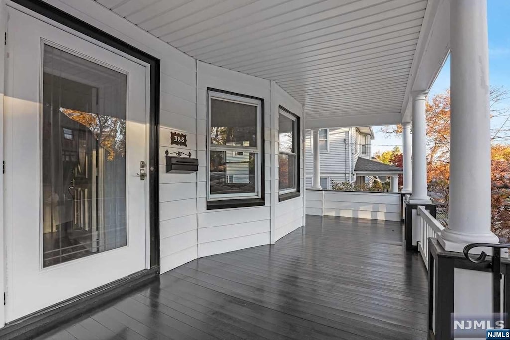 wooden terrace with a porch