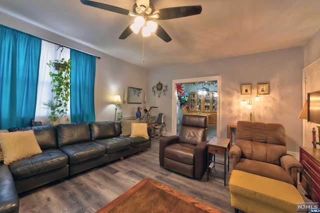 living room featuring ceiling fan and hardwood / wood-style floors