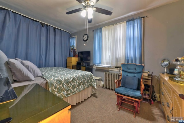 carpeted bedroom featuring ceiling fan and radiator heating unit