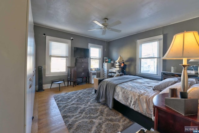 bedroom with ceiling fan and wood-type flooring