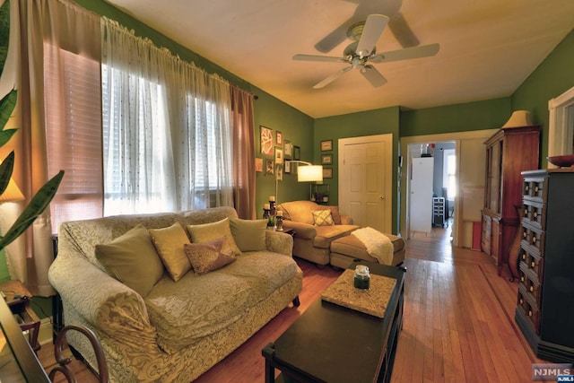 living room with hardwood / wood-style floors and ceiling fan