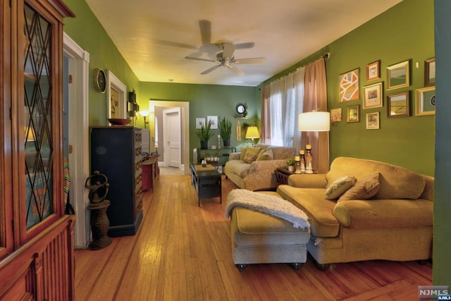 living room with ceiling fan and hardwood / wood-style floors