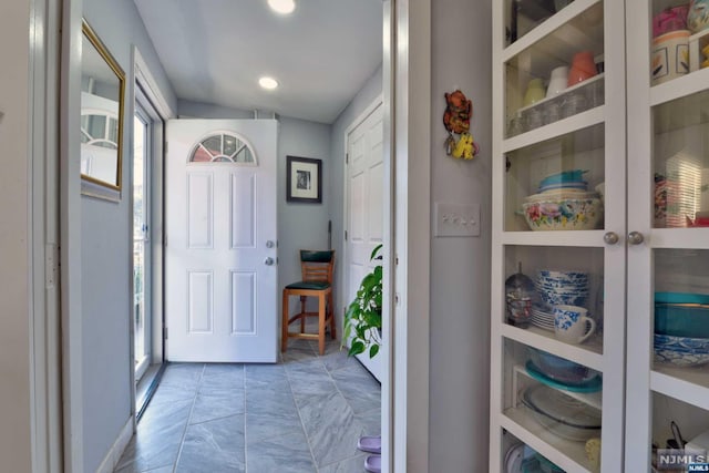 foyer entrance with a wealth of natural light and lofted ceiling